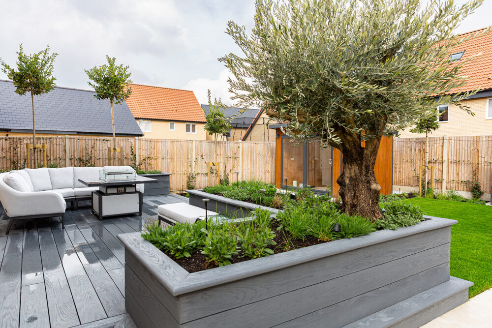 Contemporary new build garden transformation with outdoor kitchen and decking
