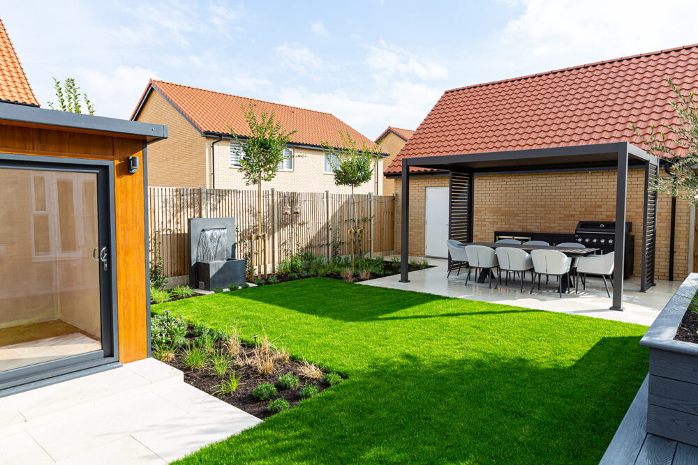 Insulated garden studio with view across patio and water feature
